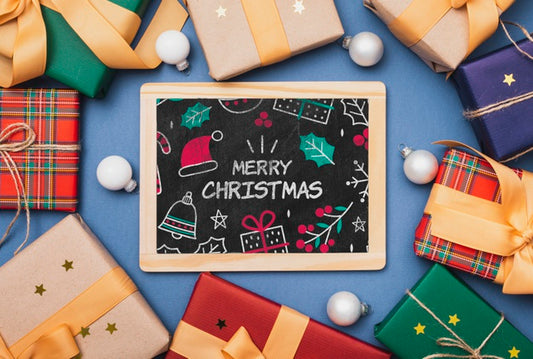 Free Top View Of Colorful Gifts And Chalkboard Psd
