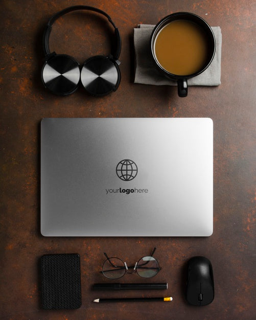 Free Top View Of Desk Surface With Laptop And Headphones Psd