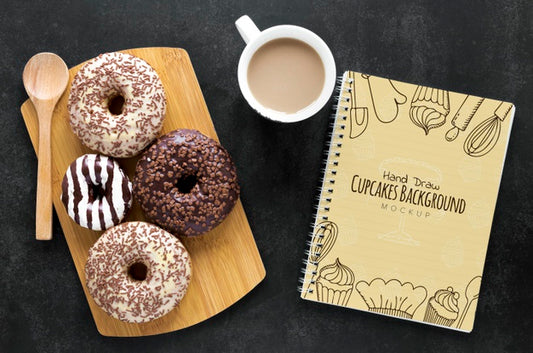 Free Top View Of Donuts With Coffee And Notebook Psd