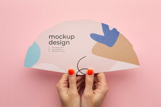 Free Top View Of Female Hands Holding Mock-Up Paper Fan Psd