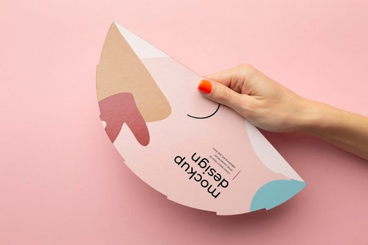 Free Top View Of Female Hands Holding Mock-Up Paper Fan Psd