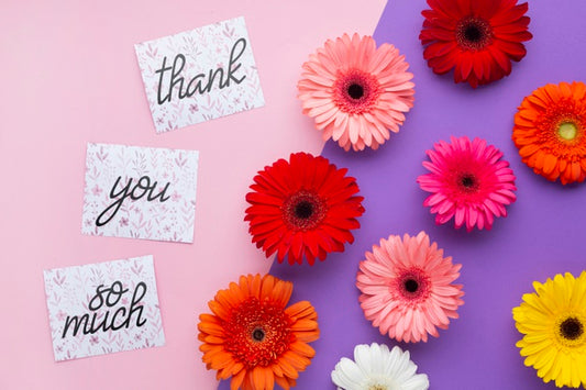 Free Top View Of Flowers And Letters On Pink And Purple Background Psd
