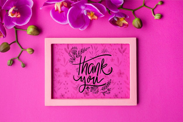 Free Top View Of Frame And Flowers On Pink Background Psd