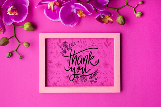 Free Top View Of Frame And Flowers On Pink Background Psd