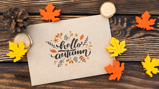 Free Top View Of Hello Autumn Paper On Wooden Table Psd