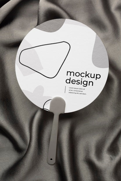 Free Top View Of Mock-Up Hand Fan On Black Textile Psd