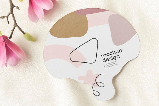 Free Top View Of Mock-Up Hand Fan With Magnolia Flowers Psd
