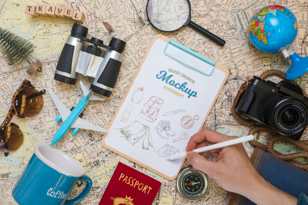 Free Top View Of Mock-Up Notepad With Traveling Essentials And Camera Psd