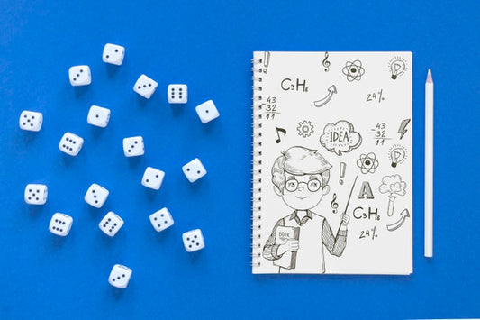 Free Top View Of Notebook With Dice And Pencil Psd