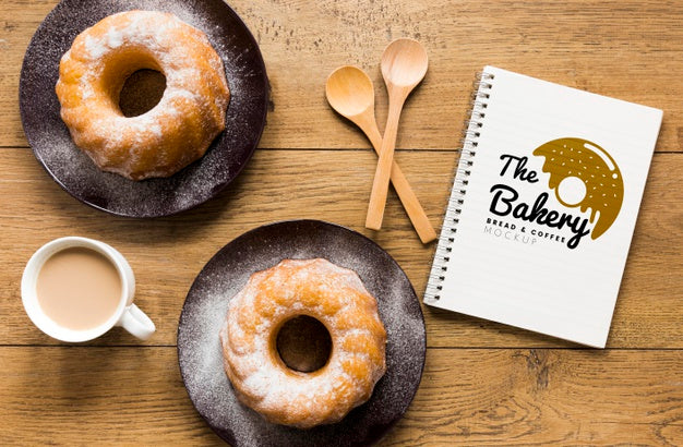 Free Top View Of Notebook With Donuts And Coffee Psd