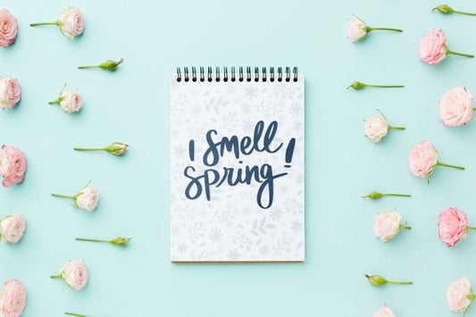 Free Top View Of Notebook With Spring Roses Psd