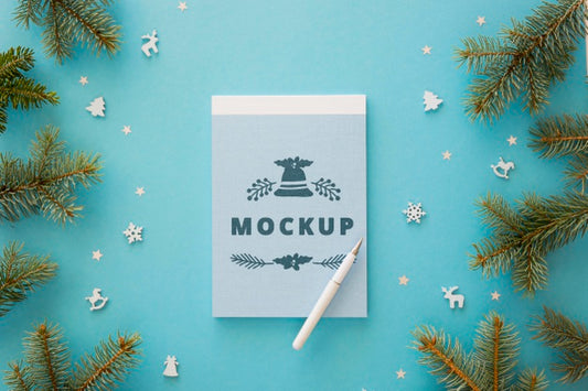 Free Top View Of Notepad With Spruce Branches And Pen Psd