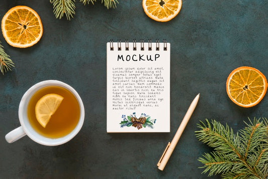 Free Top View Of Notepad With Spruce Branches And Tea Psd