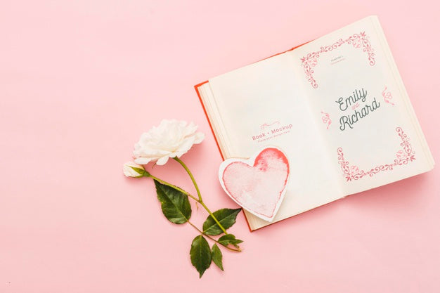 Free Top View Of Open Book With Rose And Heart Psd