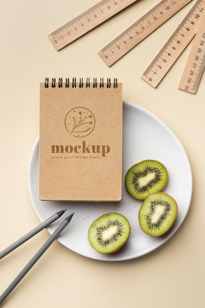 Free Top View Of Paper Stationery On Plate With Kiwi And Pencils Psd