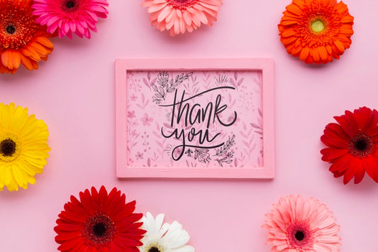Free Top View Of Pink Frame Mock-Up With Flowers Psd