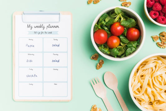 Free Top View Of Planned Meals With Bowls And Notepad Psd