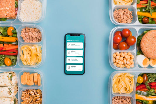 Free Top View Of Planned Meals With Smartphone Psd