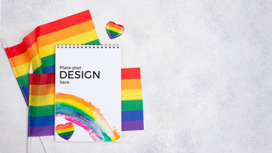 Free Top View Of Rainbow Flags And Notebook Psd
