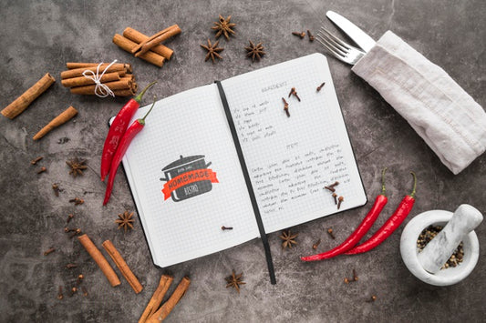 Free Top View Of Recipe Book With Cutlery And Chili Peppers Psd