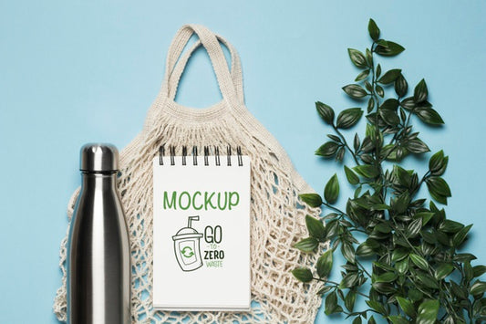 Free Top View Of Reusable Bag With Plant And Bottle Psd