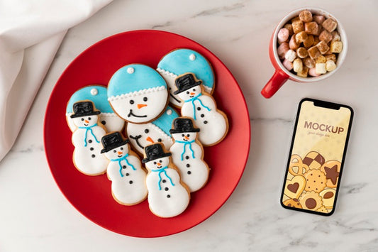 Free Top View Of Snowman Cookies With Mug And Smartphone Mock-Up Psd