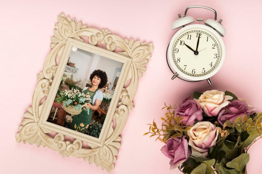 Free Top View Of Spring Rose Bouquet With Clock And Frame Psd