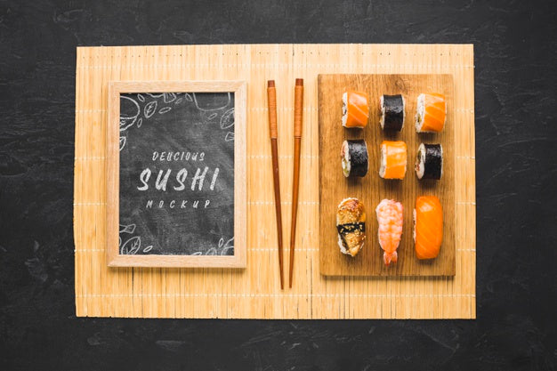 Free Top View Of Sushi On Chopping Board With Chopsticks And Blackboard Psd
