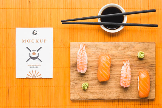 Free Top View Of Sushi On Chopping Board With Soy Sauce And Chopsticks Psd