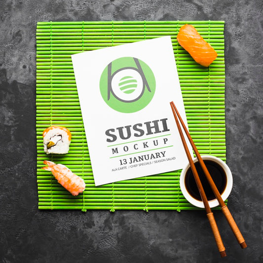 Free Top View Of Sushi With Chopsticks And Soy Sauce On Bamboo Roller Psd