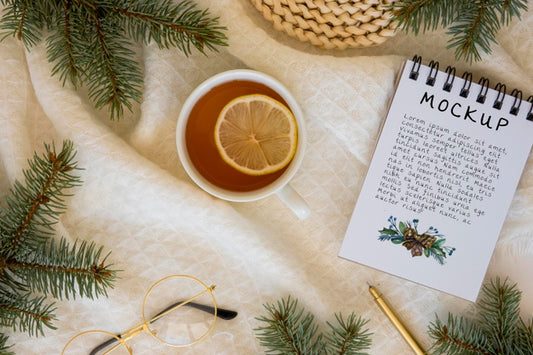 Free Top View Of Tea With Spruce Branches And Notebook Psd