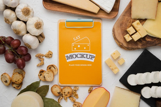 Free Top View Of Variety Of Cheese With Notepad And Garlic Psd
