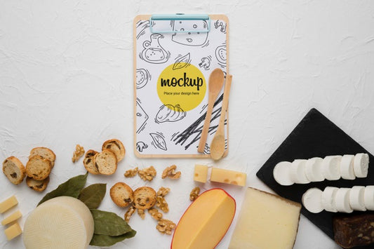 Free Top View Of Variety Of Cheese With Notepad And Walnuts Psd