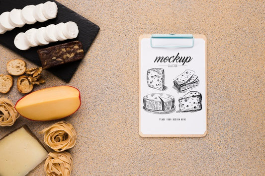 Free Top View Of Variety Of Cheese With Notepad Psd