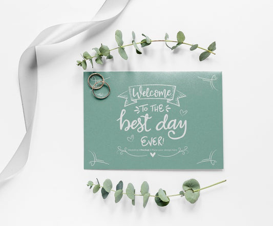 Free Top View Of Wedding Card With Plants And Rings Psd