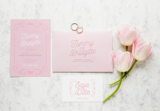 Free Top View Of Wedding Cards With Rings And Flowers Psd