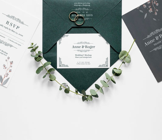 Free Top View Of Wedding Cards With Rings And Plants Psd