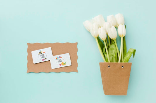 Free Top View Of White Tulips And Cards Psd