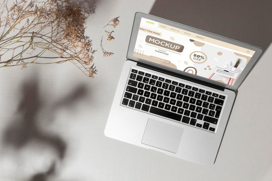 Free Top View Opened Laptop With Screen Mockup Next To Leaves Psd