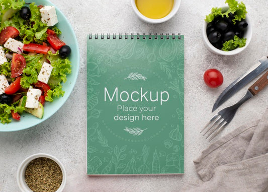 Free Top View Salad And Notebook Arrangement Psd