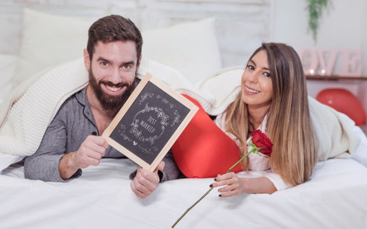 Free Valentine Mockup With Couple In Bed Showing Slate Psd