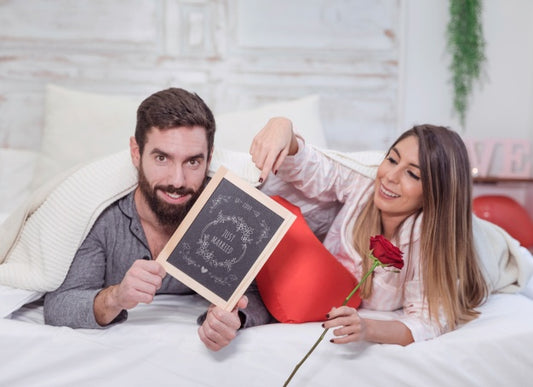 Free Valentine Mockup With Couple In Bed Showing Slate Psd