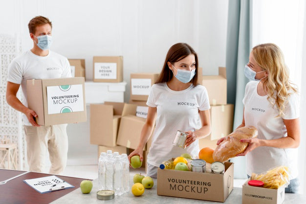 Free Volunteers With Medical Masks Preparing Provision Boxes For Donation Psd