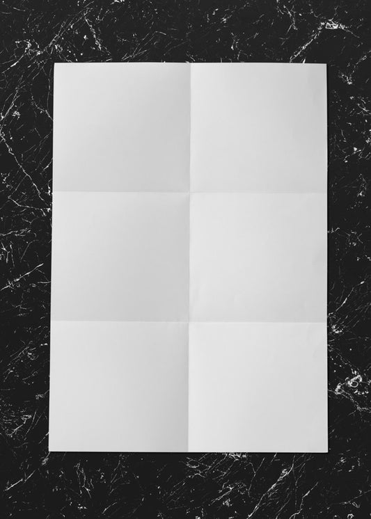 Free White Folded Paper On Marble Mockup Psd