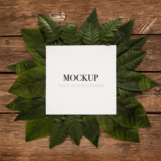 Free White Frame For Mockup With Border Leaves On Wood Psd