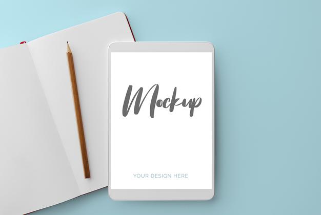 Free White Tablet On Blue With Notebook And Pencil Mockup Psd