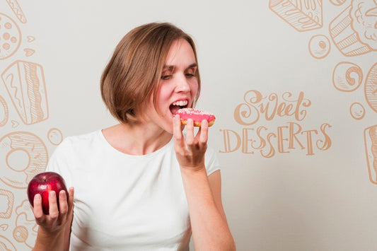 Free Woman Eating A Donut And An Apple Psd