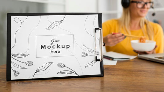 Free Woman Eating At Desk With Clipboard Mock-Up Psd