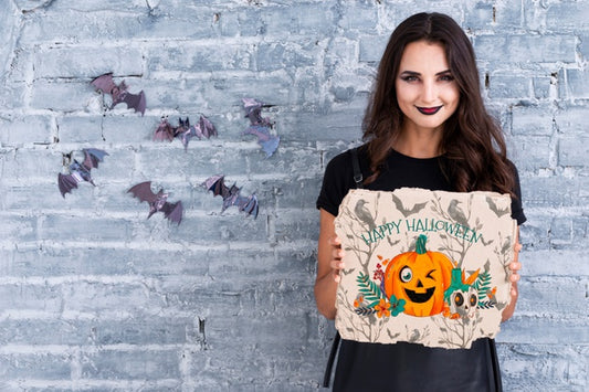 Free Woman Holding A Card With Carved Pumpkin For Halloween Psd