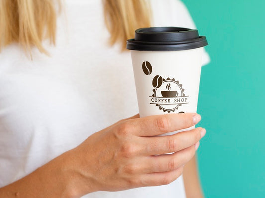 Free Woman Holding A Coffee Paper Cup Mock-Up Psd